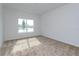 A bedroom with carpet floors, a window and neutral colored walls at 5009 Balsam Falls Rd, Deland, FL 32724