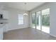 An empty dining area featuring sliding doors, tile floors and natural light at 5009 Balsam Falls Rd, Deland, FL 32724