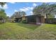 View of backyard with patio, wooden fence and manicured landscaping at 501 Cherry Tree St, Eustis, FL 32726