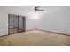 Bright bedroom with neutral carpeting, ceiling fan, and sliding glass door to the exterior at 501 Cherry Tree St, Eustis, FL 32726