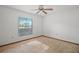 Bright bedroom with window and ceiling fan with carpet flooring at 501 Cherry Tree St, Eustis, FL 32726