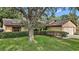 Charming single-story home with a well-maintained lawn and privacy landscaping, offering curb appeal at 501 Cherry Tree St, Eustis, FL 32726