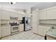 Efficient kitchen with white cabinets, stainless steel appliances, and durable tile flooring at 501 Cherry Tree St, Eustis, FL 32726