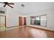 Bright living space showcasing hardwood floors, a ceiling fan, and a bay window for added charm at 501 Cherry Tree St, Eustis, FL 32726