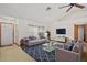 Bright living room with tile and carpet flooring, fan, and large window providing ample light at 501 Cherry Tree St, Eustis, FL 32726