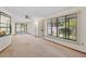 Living room with large windows offering plenty of natural light and a view of the landscaped yard at 501 Cherry Tree St, Eustis, FL 32726