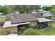 Low angle of rear exterior showing multiple additions and yard with mature landscaping at 501 Cherry Tree St, Eustis, FL 32726