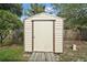 Close-up of a storage shed with ramp and closed door in backyard at 501 Cherry Tree St, Eustis, FL 32726
