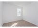 Bright bedroom featuring neutral carpet, white walls, and a window offering plenty of natural light at 5017 Balsam Falls Rd, Deland, FL 32724