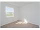 Cozy bedroom with carpet flooring and a large window overlooking a green lawn at 5017 Balsam Falls Rd, Deland, FL 32724