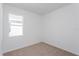 Bright bedroom featuring neutral carpet, white walls, and a window offering plenty of natural light at 5017 Balsam Falls Rd, Deland, FL 32724