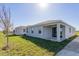 A well maintained home exterior featuring a covered patio and lush lawn at 5017 Balsam Falls Rd, Deland, FL 32724