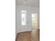 Bright foyer with wood-look tile floors and a clear view of the entry door at 5017 Balsam Falls Rd, Deland, FL 32724