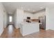 Open-concept kitchen featuring white cabinetry, stainless steel appliances, and center island at 5017 Balsam Falls Rd, Deland, FL 32724