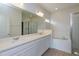 Primary bathroom featuring dual sinks, a soaking tub, and a separate glass-enclosed shower at 5025 Balsam Falls Rd, Deland, FL 32724