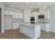 Bright kitchen with white cabinets, an island with a sink, stainless steel appliances and stylish flooring at 5025 Balsam Falls Rd, Deland, FL 32724