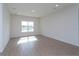 Sunlit living room with tile flooring, window with view, and ample space for furnishings at 5025 Balsam Falls Rd, Deland, FL 32724