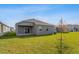 Wide backyard with green grass and a modern home's side profile at 5036 Balsam Falls Rd, Deland, FL 32724
