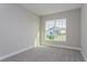 Comfortable bedroom with a large window offering neighborhood views at 5036 Balsam Falls Rd, Deland, FL 32724