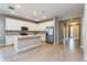 Bright kitchen boasts white cabinets, stainless steel appliances, and a center island at 5036 Balsam Falls Rd, Deland, FL 32724