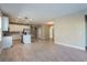 Bright open-concept kitchen with white cabinets, stainless steel appliances, and an island at 5036 Balsam Falls Rd, Deland, FL 32724