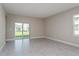 Large living space featuring neutral paint, tiled flooring, and a sliding glass door at 5036 Balsam Falls Rd, Deland, FL 32724