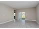 Bright living area featuring neutral paint, tiled flooring, and a sliding glass door at 5036 Balsam Falls Rd, Deland, FL 32724