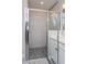 Close-up of the shower, which features black tile on the floor and white tile on the wall at 5036 Balsam Falls Rd, Deland, FL 32724
