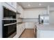 Stylish kitchen with stainless steel appliances, white cabinets, subway tile backsplash, and a center island at 5037 Balsam Falls Rd, Deland, FL 32724