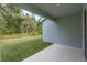 Covered lanai with concrete flooring, offering an outdoor seating area and a view of the backyard at 5037 Balsam Falls Rd, Deland, FL 32724