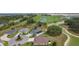 Aerial view showing home's backyard, landscaping, and proximity to the golf course and neighborhood at 5944 Hickey Way, The Villages, FL 32163
