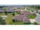 Aerial view of home showcasing its backyard, surrounding neighborhood, and proximity to a pond at 5944 Hickey Way, The Villages, FL 32163