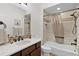 Bathroom with a modern vanity, decorative mirror, and a tiled shower with bathtub at 5944 Hickey Way, The Villages, FL 32163