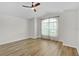 Bright bedroom featuring wood-look flooring and a vaulted ceiling with a modern ceiling fan at 5944 Hickey Way, The Villages, FL 32163