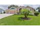 Well-manicured front lawn and landscaping highlight the exterior of this home at 5944 Hickey Way, The Villages, FL 32163