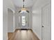 Bright foyer with beautiful door and sidelight design at 5944 Hickey Way, The Villages, FL 32163