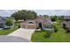 Charming home featuring a well-manicured lawn, three-car garage, and inviting curb appeal in a desirable community at 5944 Hickey Way, The Villages, FL 32163