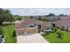 Charming home with lush landscaping, three-car garage, and inviting curb appeal in a desirable community at 5944 Hickey Way, The Villages, FL 32163