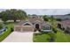 Charming home featuring a well-manicured lawn, three-car garage, and inviting curb appeal in a desirable community at 5944 Hickey Way, The Villages, FL 32163