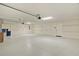 Spacious three car garage featuring ample storage, epoxy floor, and overhead lighting at 5944 Hickey Way, The Villages, FL 32163