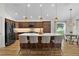 Spacious kitchen featuring a large island with seating, pendant lighting, and stainless steel appliances at 5944 Hickey Way, The Villages, FL 32163