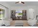 Cozy living room with built-in shelving, modern seating, and access to the outdoor patio at 5944 Hickey Way, The Villages, FL 32163