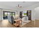 Bright, open-concept living room with stylish furnishings and sliding glass doors to outdoor patio at 5944 Hickey Way, The Villages, FL 32163
