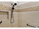 Bathroom shower with mosaic tile accents and updated fixtures at 5944 Hickey Way, The Villages, FL 32163