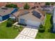Lovely home with solar panels nestled in a neighborhood of homes with manicured lawns at 735 Palma Dr, Lady Lake, FL 32159