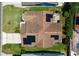 Birds eye view of home featuring solar panels, a white brick pattern driveway, and green landscaping at 735 Palma Dr, Lady Lake, FL 32159