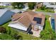 Aerial view of home with solar panels, a patio, grill, and a quaint swing for outdoor enjoyment at 735 Palma Dr, Lady Lake, FL 32159