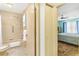 Bathroom featuring a shower-tub combo, and a glimpse into the adjacent bedroom at 735 Palma Dr, Lady Lake, FL 32159