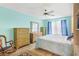 Cozy bedroom with wood floors, ceiling fan, and bright blue walls at 735 Palma Dr, Lady Lake, FL 32159