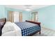 Cozy bedroom with tile floors, neutral walls, and window with curtains at 735 Palma Dr, Lady Lake, FL 32159